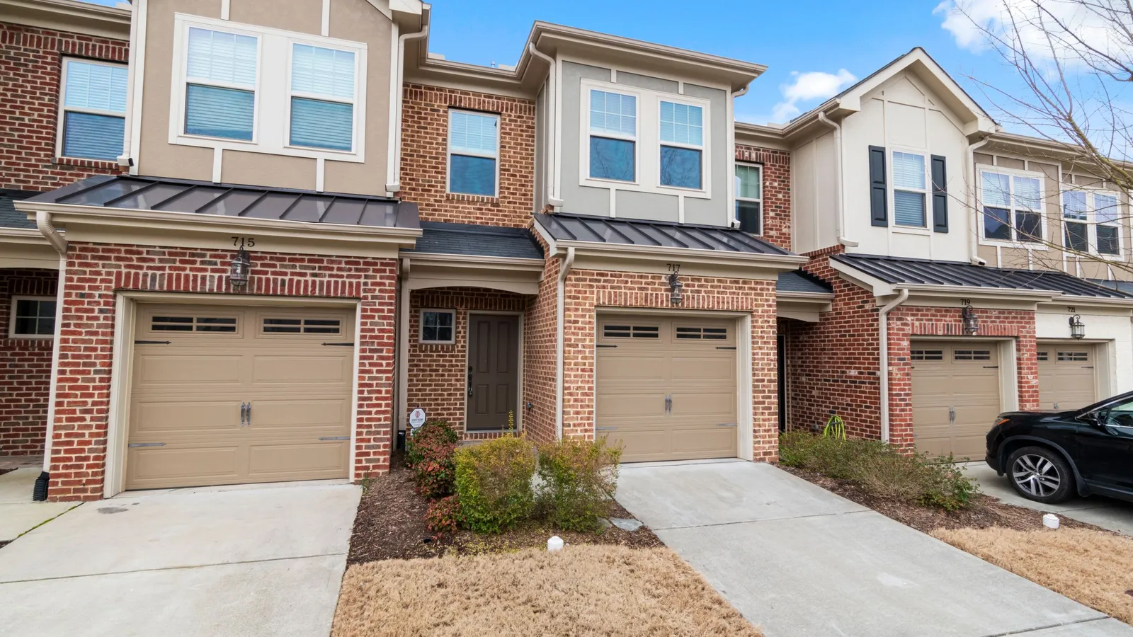 Row of attached brick townhomes with matching rooflines