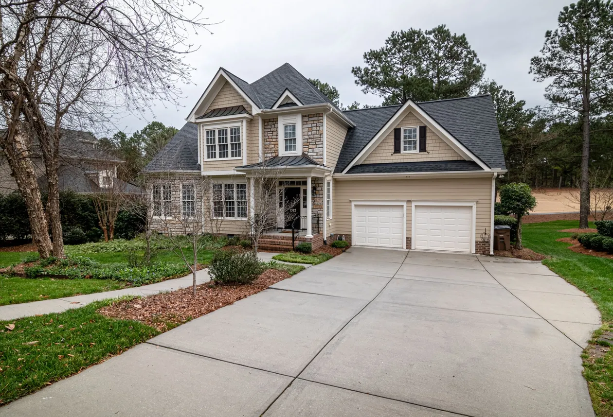 Two-story suburban home with a dark architectural shingle roof