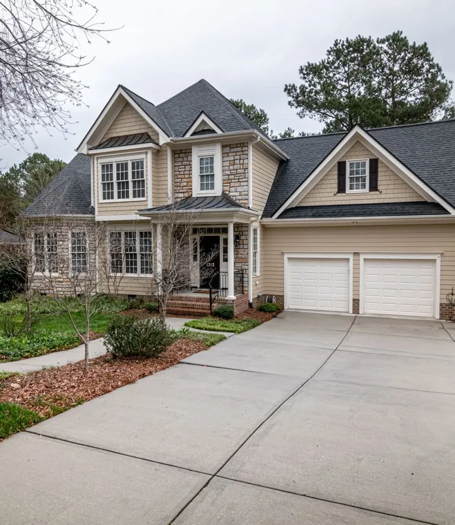 Two-story suburban home with a dark architectural shingle roof