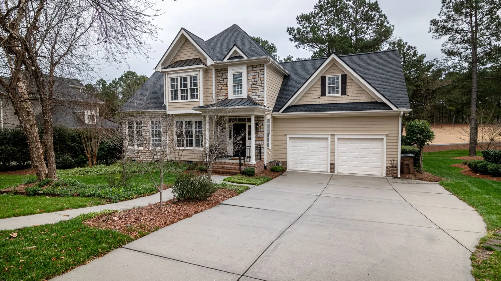 Two-story suburban home with a dark architectural shingle roof