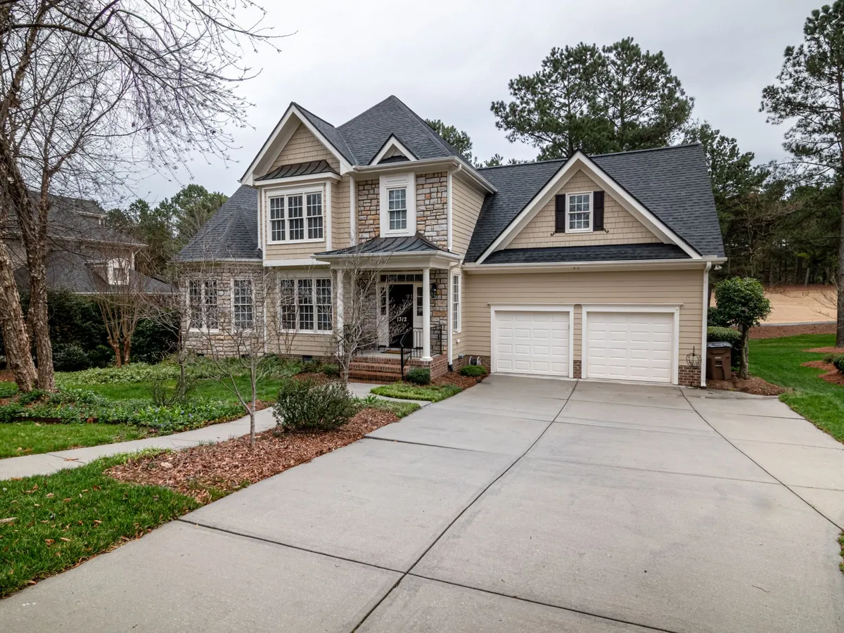 Two-story suburban home with a dark architectural shingle roof